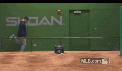 A Man Is Running On A Baseball Field In Front Of A Wall That Says Siddan GIF