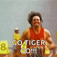 a man is running on a track with the words `` go tiger go '' written on it .