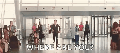 A Man Is Running Through An Airport With A Suitcase And Asking Where Are You . GIF