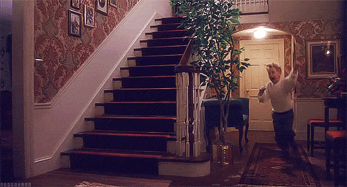 A Man Is Running Up A Set Of Stairs In A Home GIF