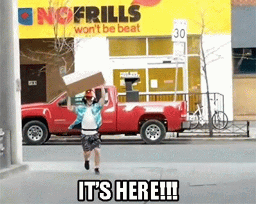 A Man Is Running With A Cardboard Box In Front Of A No Frills Sign GIF
