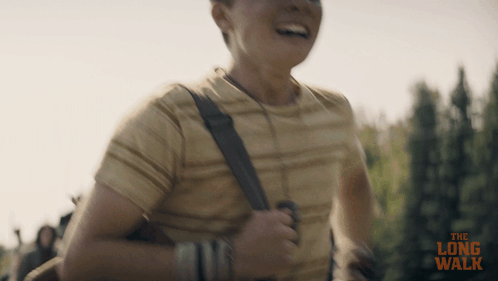 A Man Is Running With The Long Walk Written On The Bottom Of The Image GIF