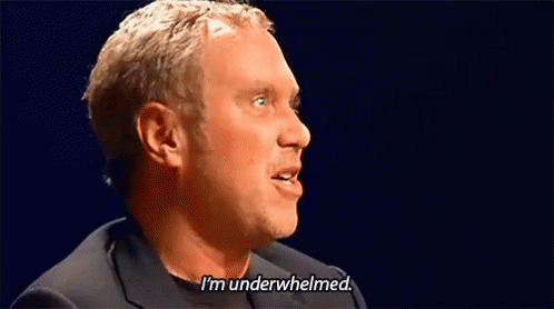 A Man Is Saying I 'M Underwhelmed In A Dark Room . GIF