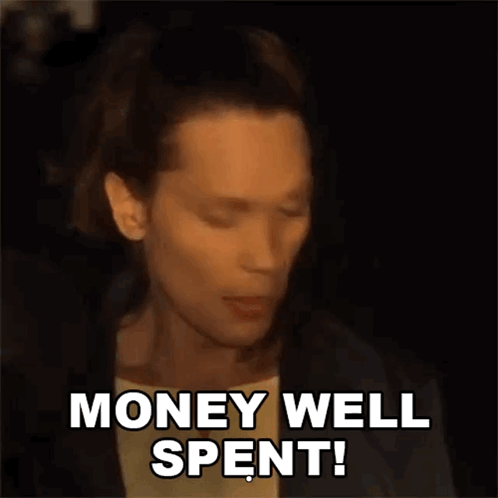 A Man Is Saying Money Well Spent In A Dark Room GIF