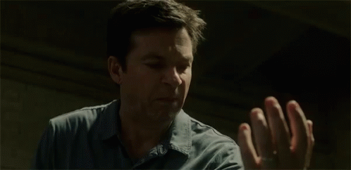 A Man Is Screaming And Holding His Hands Up With The Word Blood Written Next To Him . GIF