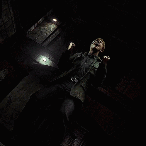 A Man Is Screaming In A Dark Room With A Light On The Wall GIF