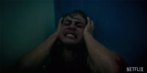 A Man Is Screaming In A Shower With A Netflix Logo Behind Him GIF