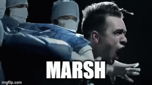 A Man Is Screaming In Front Of A Group Of Surgeons And The Word Marsh Is On The Bottom Of The Image . GIF