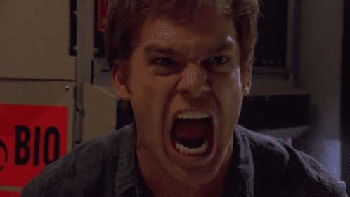 A Man Is Screaming In Front Of A Red Sign That Says Bio On It GIF