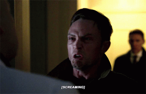 A Man Is Screaming While Another Man Watches GIF