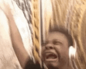 A Man Is Screaming While Wearing Headphones And Holding A Sword In His Hand . GIF