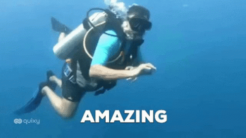 A Man Is Scuba Diving In The Ocean And The Word Amazing Is On The Bottom Of The Picture . GIF