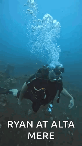 A Man Is Scuba Diving In The Ocean With The Words `` Ryan At Alta Mere '' Written Above Him . GIF