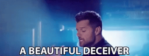 A Man Is Singing A Song And The Words A Beautiful Deceiver Are Next To Him GIF