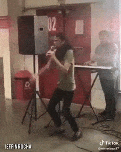 Man Singing Into Microphone With Keyboard GIF
