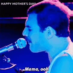 A Man Is Singing Into A Microphone With The Words `` Mama Ooh '' . GIF