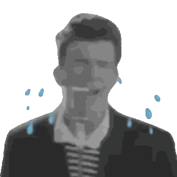 a man is singing into a microphone with water drops falling on his face