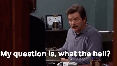 A Man Is Sitting At A Desk In An Office Talking To A Woman And Saying `` My Question Is , What The Hell ? '' GIF