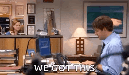 A Man Is Sitting At A Desk In Front Of A Computer With The Words `` We Got This '' Written On The Screen . GIF