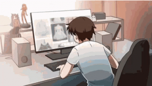 A Man Is Sitting At A Desk Looking At A Computer Monitor GIF