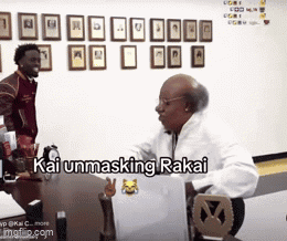 A Man Is Sitting At A Desk With A Laptop And The Words Kai Unmasking Rakai Written On The Screen GIF