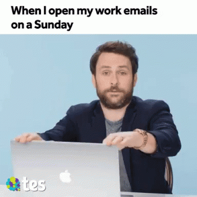 A Man Is Sitting At A Desk With A Laptop And The Words When I Open My Work Emails On A Sunday GIF