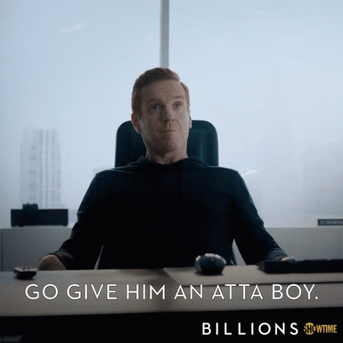 A Man Is Sitting At A Desk With The Words Billions Below Him GIF