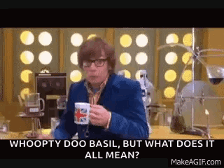 A Man Is Sitting At A Table Holding A Cup Of Coffee And Talking . GIF