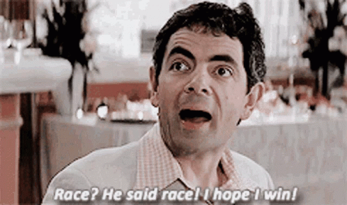 A Man Is Sitting At A Table In A Restaurant With His Mouth Open And Talking . GIF