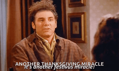 A Man Is Sitting At A Table Talking To A Woman And Saying Another Thanksgiving Miracle GIF