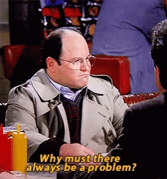 A Man Is Sitting At A Table Talking To Another Man And Says Why Must There Always Be A Problem . GIF