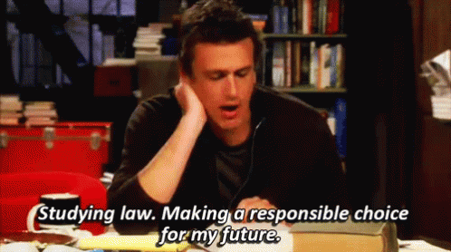 A Man Is Sitting At A Table With A Book And Says " Studying Law Making A Responsible Choice For My Future " . GIF