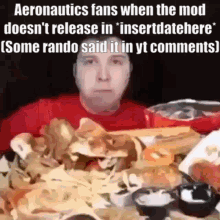 A Man Is Sitting At A Table With A Bunch Of Food On It . GIF
