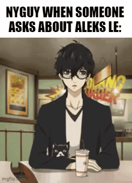 A Man Is Sitting At A Table With A Cup Of Coffee And A Cat On His Lap . GIF