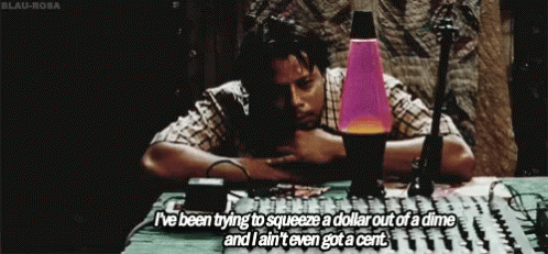 A Man Is Sitting At A Table With A Lava Lamp And Says I 'Ve Been Trying To Squeeze A Dollar Out GIF