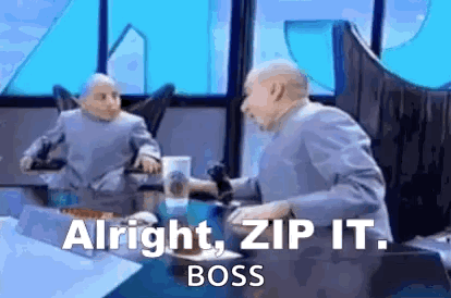 A Man Is Sitting At A Table With A Microphone In His Hand And Says `` Alright , Zip It . Boss '' . GIF