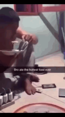 A Man Is Sitting At A Table With A Phone And A Bowl Of Food With The Caption Bro Ate The Hottest Food Ever GIF