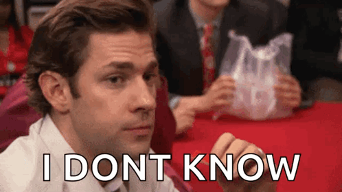 A Man Is Sitting At A Table With A Plastic Bag In His Hand And The Words `` I Don T Know '' Written On His Face GIF
