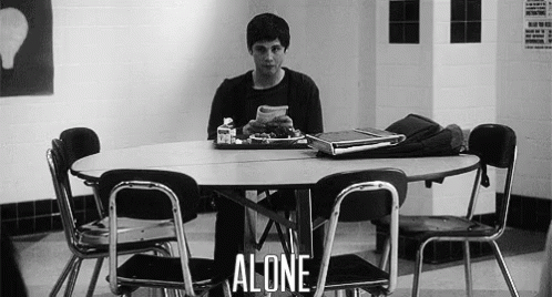 A Man Is Sitting At A Table With A Tray Of Food And A Laptop . GIF
