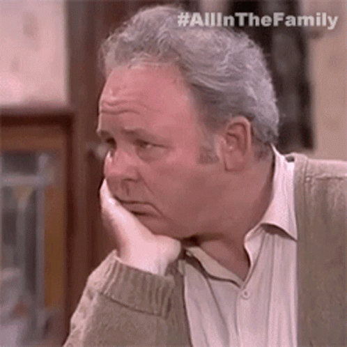 Man Sitting With Hand On Face GIF