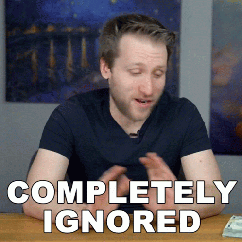 A Man Is Sitting At A Table With The Words Completely Ignored On The Screen GIF