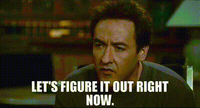 A Man Is Sitting At A Table With The Words `` Let 'S Figure It Out Right Now '' Written On The Screen . GIF