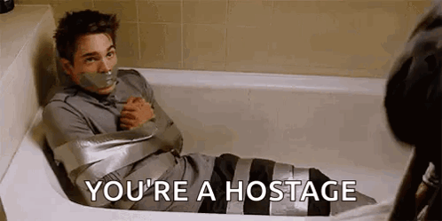 A Man Is Sitting In A Bathtub Wrapped In Duct Tape And Says `` You 'Re A Hostage '' . GIF