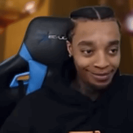 A Man Is Sitting In A Black And Blue Gaming Chair . GIF