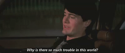 A Man Is Sitting In A Car And Talking To Someone . GIF