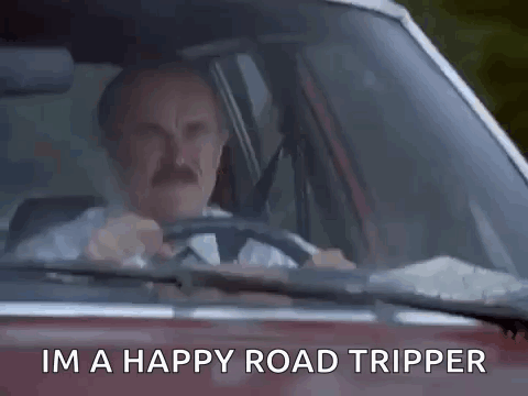 A Man Is Sitting In A Car Giving The Middle Finger . GIF