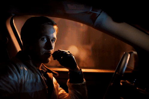 A Man Is Sitting In A Car With A Red Arrow Pointing To His Face GIF