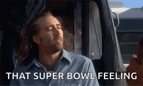 A Man Is Sitting In A Car With His Eyes Closed And The Words That Super Bowl Feeling Above Him GIF