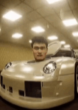A Man Is Sitting In A Car With His Head In The Trunk . GIF