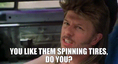 A Man Is Sitting In A Car With The Words `` You Like Them Spinning Tires , Do You ? '' On The Screen . GIF